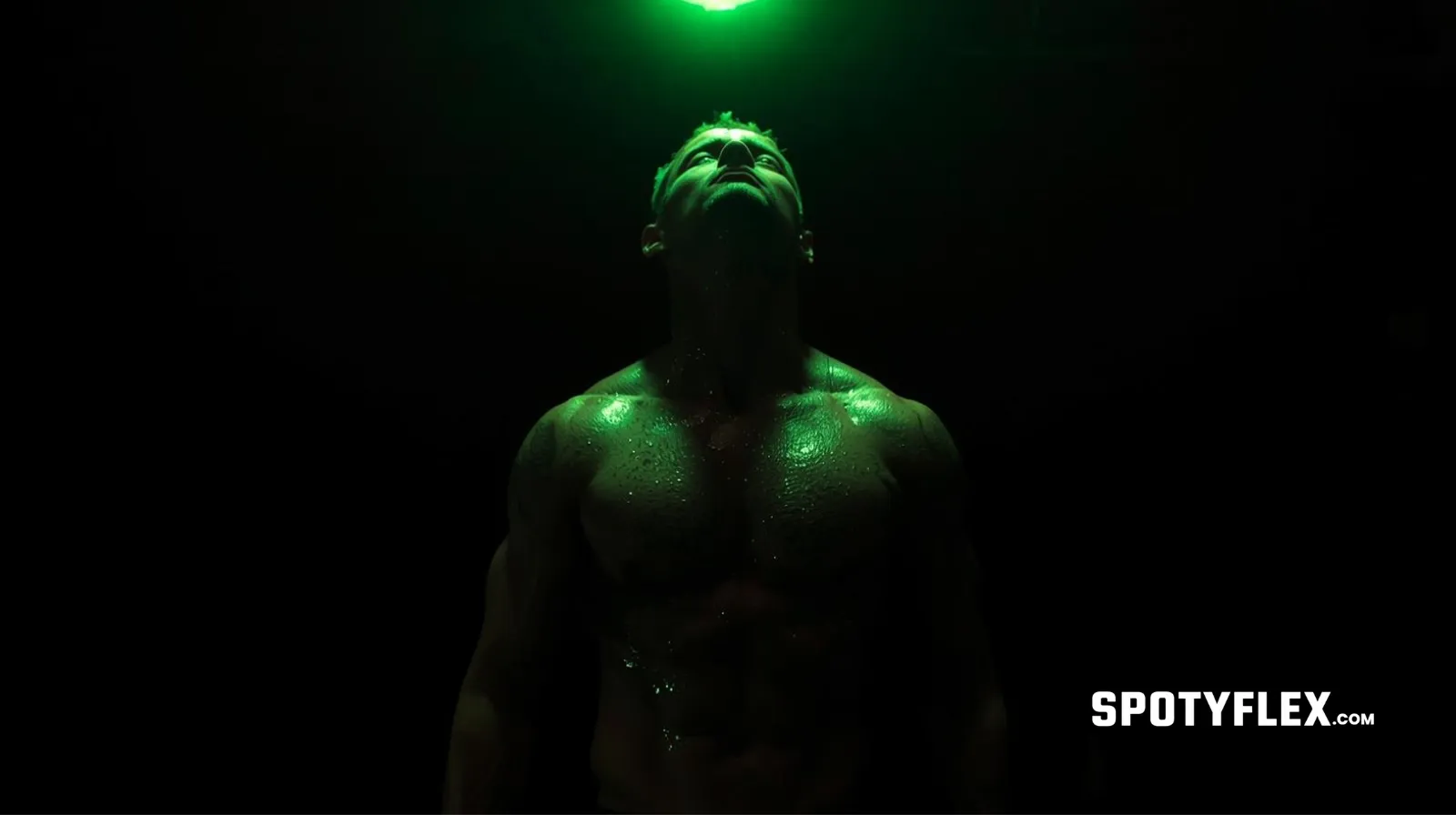 Shredded male athlete drenched in sweat under a neon green spotlight in a dark gym, with hard shadows and visible forearm veins.