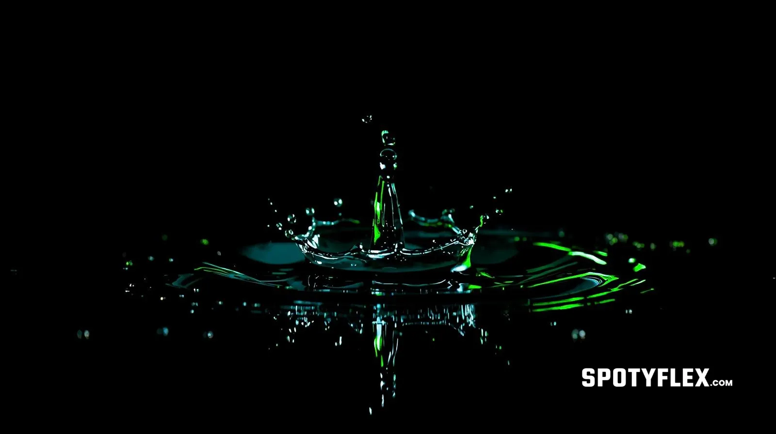 Macro shot of a water droplet frozen above a black mirror surface, lit by neon green light, with scattered droplets around it.