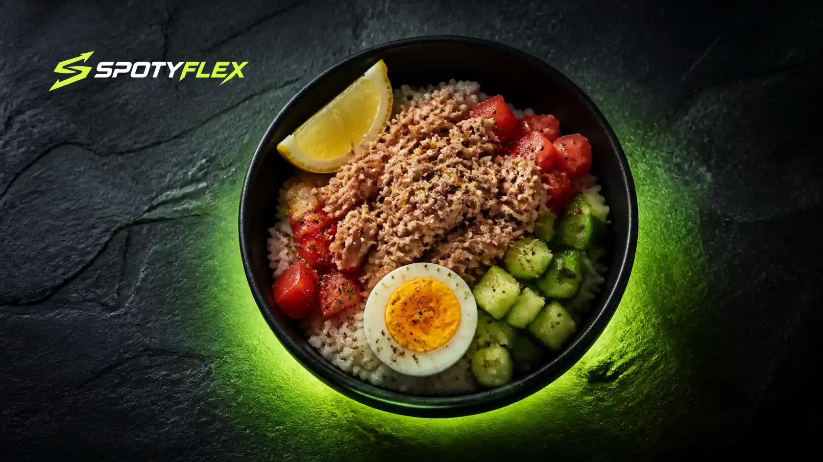 A rice bowl topped with tuna, tomato, cucumber and a boiled egg.